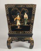 A BLACK LACQUERED PLANTER on a stand. 18ins high.