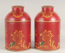 A PAIR OF TOLEWARE TEA TINS AND COVERS. 15ins high.