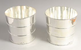 A PAIR OF SILVER PLATED BARREL COOLERS. 7.5ins high.