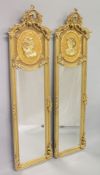 A PAIR OF FRENCH STYLE GILTWOOD TALL DRESSING MIRRORS, the upper panels moulded with the busts of