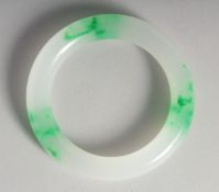 A CHINESE TWO TONE JADE BANGLE. 3.25ins diameter.