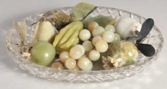 A CUT GLASS OVAL BOWL OF JADE FRUITS.