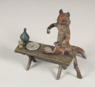 A SMALL VIENNA BRONZE GROUP OF A FOX COOKING. 8.25ins long.