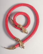A RED SNAKE NECKLACE AND BRACELET.