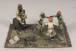 AN AUSTRIAN PAINTED COLD CAST GROUP, boys playing. 7.5ins long.