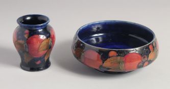 WILLIAM MOORCROFT POMEGRANATE CIRCULAR BOWL on a blue ground. W. M. initials, impressed,