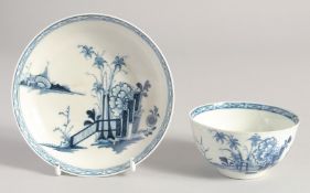 A LIVERPOOL TEABOWL AND SAUCER painted in blue with the Peony Bamboo and Fence pattern.