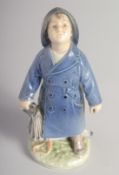 A ROYAL COPENHAGEN FIGURE SAILOR BOY in a blue coat. No.3556. 7ins high.