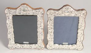 A PAIR OF REPOUSSE PHOTOGRAPH FRAMES, 7.5ins x 5.5ins.