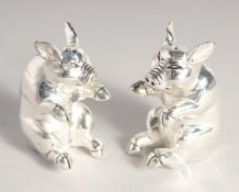 A PAIR OF SILVER PLATED PIG SALT AND PEPPERS.