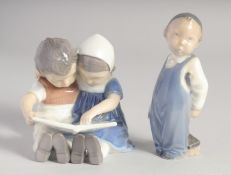 A ROYAL COPENHAGEN GROUP OF TWO CHILDREN READING A BOOK, No.1567, 3.5ins high and a YOUNG BOY, No.