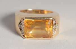 A GOLD CITRINE AND DIAMOND RING.
