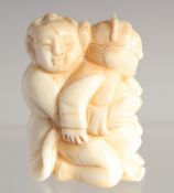 A CARVED BONE EROTIC NETSUKE. 1.5ins long.