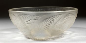 A LALIQUE CIRCULAR BOWL with flowers in iridescent blue. 9ins diameter. Mark: R. LALIQUE, FRANCE.