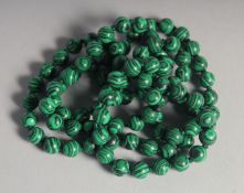 A STRING OF MALACHITE BEADS.