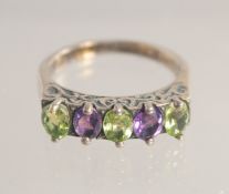 A SILVER PERIDOT AND AMETHYST RING.