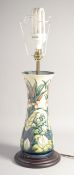A GOOD MOORCROFT PORCELAIN LAMP on a wooden base. 12ins high.