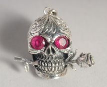 A SILVER SKULL AND ROSE PENDANT.