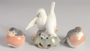 TWO ROYAL COPENHAGEN ROBINS, No. 2266, 2.5ins and a PAIR OF DOVES, No. 402, 5ins high (2).