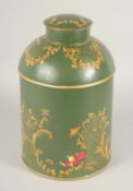 A GREEN TOLEWARE TEA TIN AND COVER. 15ins high.