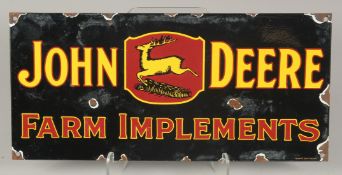 AN ENAMEL `JOHN DEER' SIGN. 8ins x 17ins.