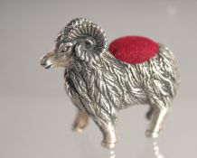 A SILVER RAM PIN CUSHION.