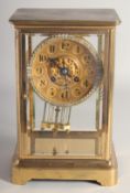 A GOOD BRASS FOUR GLASS CLOCK, made in Paris for James Shoolbred & Co., London. The dial with