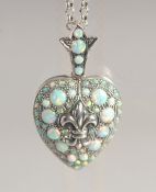 A SILVER OPAL SET HEART SHAPED LOCKET.
