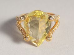A SILVER GILT TEAR DROP CITRINE RING.
