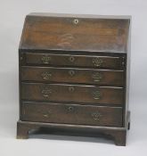 A GEORGE III OAK BUREAU with front fitted interior, four long graduated drawers on bracket feet. 3ft
