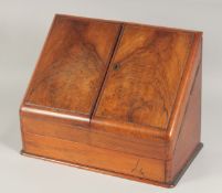 A VICTORIAN WALNUT FOLDING FRONT STATIONARY BOX with fitted interior. 15ins long.