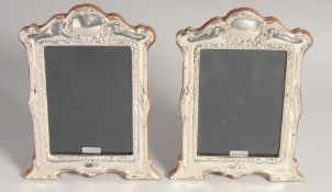 A PAIR OF ROCOCO DESIGN PHOTOGRAPH FRAMES. 8ins x 8.5ins.