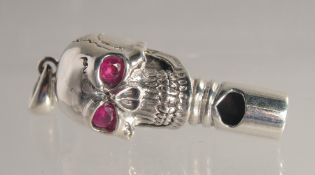 A SILVER SKULL WHISTLE.