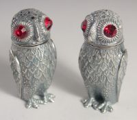 A PAIR OF SILVER PLATED OWL SALT AND PEPPERS.