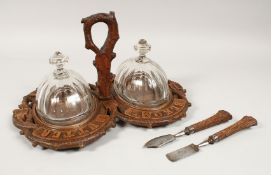 A RARE 19TH CENTURY BLACK FOREST CARVED WOOD SERVING TRAY with carrying handles, glass dishes and