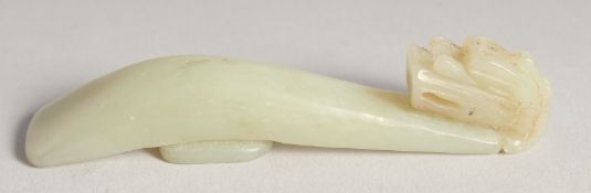 A CHINESE CARVED JADE BELT HOOK.