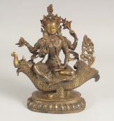 A CHINESE BRONZE GOD FIGURE riding a dragon sat with turquoise and coral. 10ins high.