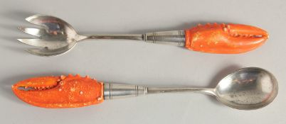 A PAIR OF SILVER PLATED SALAD SERVERS carved with lobster claw handles.