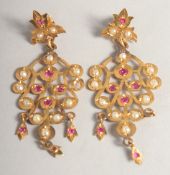 A PAIR OF YELLOW METAL, RUBY AND PEARL, LEAF SHAPED EARRINGS.
