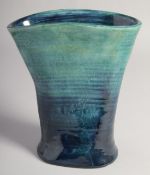 WILLIAM MOORCROFT SHAPED BLUE TINTED VASE. Script W. M., etched W. Moorcroft. 7.5ins high.