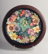 MOORCROFT CAROUSEL DESIGN CIRCULAR CHARGER in an oval frame. Signed Rachel Bishop, no. 208. 12ins