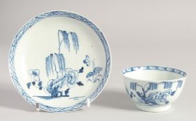 A LIVERPOOL CHAFFERS FACTORY TEABOWL AND SAUCER painted in blue with a willow tree behind a rock,