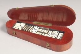 A SMALL WOODEN COFFIN SHAPED BOX with dice.