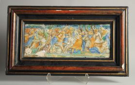 AN EARLY MAJOLICA PLAQUE, POSSIBLY 15TH -16TH CENTURY. A battle scene 7ins x 18ins frame (A/F).