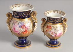 TWO ENGLISH BLUE GROUND URNS painted with a panel of flowers. 5.5ins x 4.5ins high.