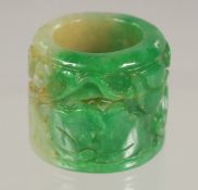 A CARVED JADE ARCHERS RING.
