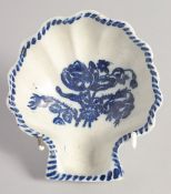 A LIVERPOOL SHELL SHAPED DISH on peg feet printed with flowers under a painted border.