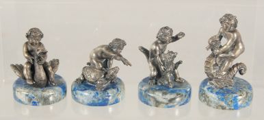 A GOOD SET OF FOUR SILVER AND LAPIS CHERUBS, each riding: a swan, a turtle, a seahorse and a fox, on