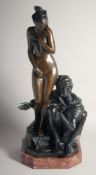A GOOD BRONZE OF AN ARAB WITH A STANDING NUDE. Signed, on a marble base. 28ins high.