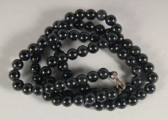 A STRING OF BLACK JET BEADS.